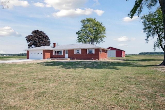 single story home with a garage and a front lawn