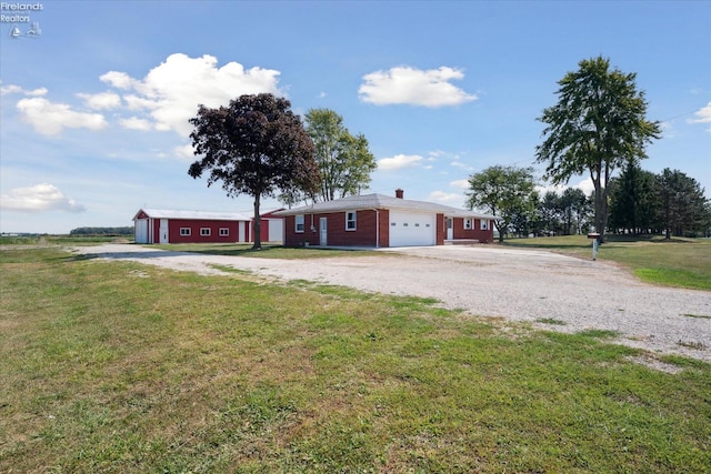 single story home featuring a garage and a front lawn