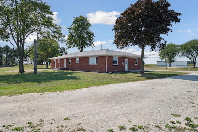 view of side of property featuring a yard