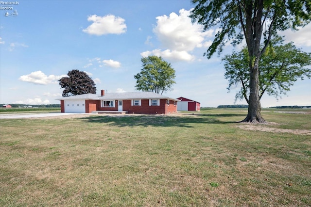 ranch-style home with a garage and a front lawn