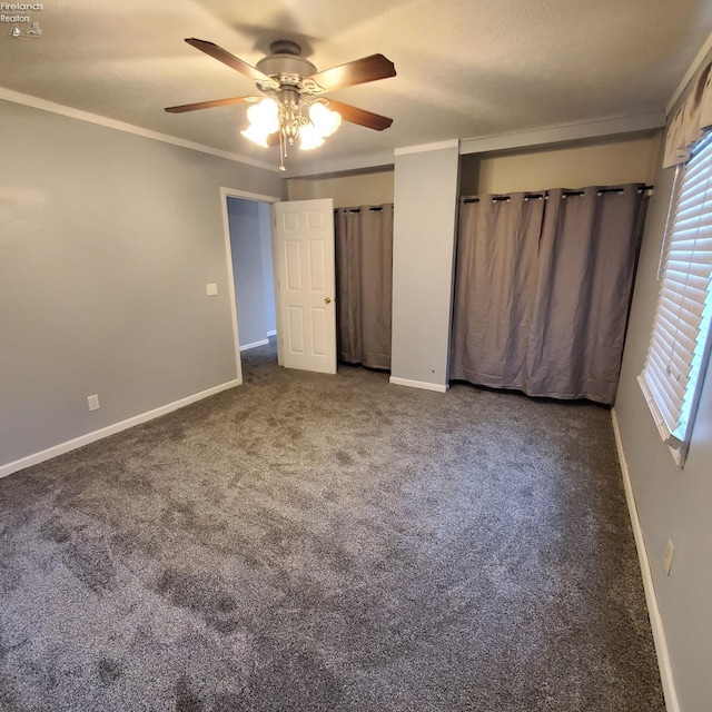 unfurnished bedroom featuring crown molding, carpet floors, and ceiling fan