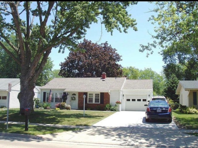 ranch-style house with a garage and a front lawn