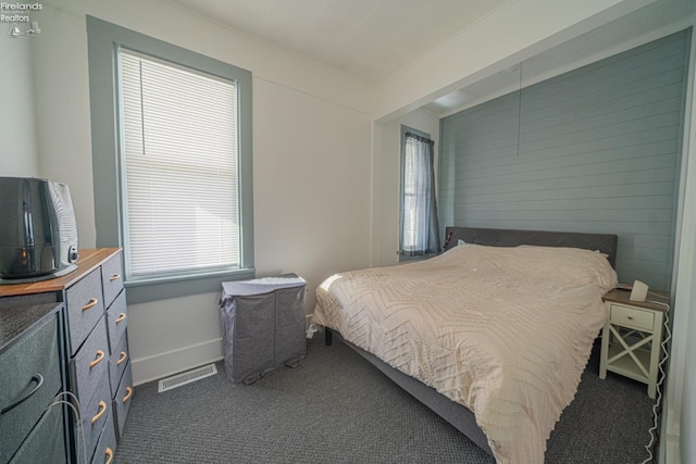 bedroom featuring dark colored carpet