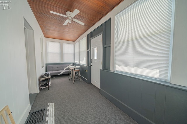 sunroom / solarium featuring wooden ceiling and ceiling fan