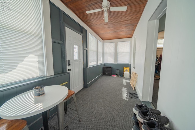 sunroom / solarium featuring wood ceiling and ceiling fan