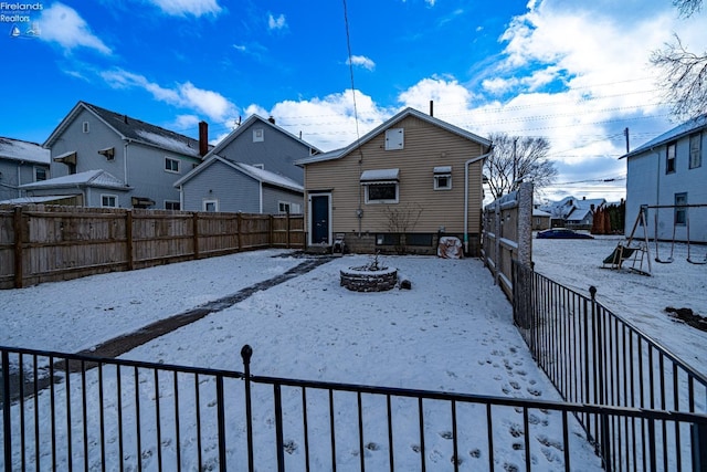 view of snow covered rear of property