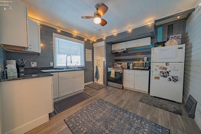 kitchen featuring white cabinetry, sink, hardwood / wood-style floors, and appliances with stainless steel finishes