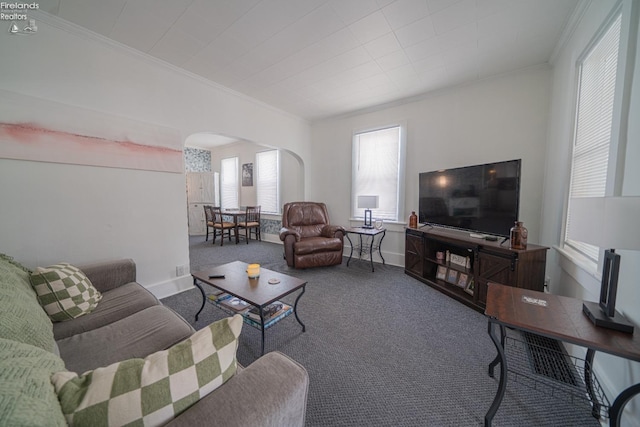 living room with ornamental molding and carpet flooring