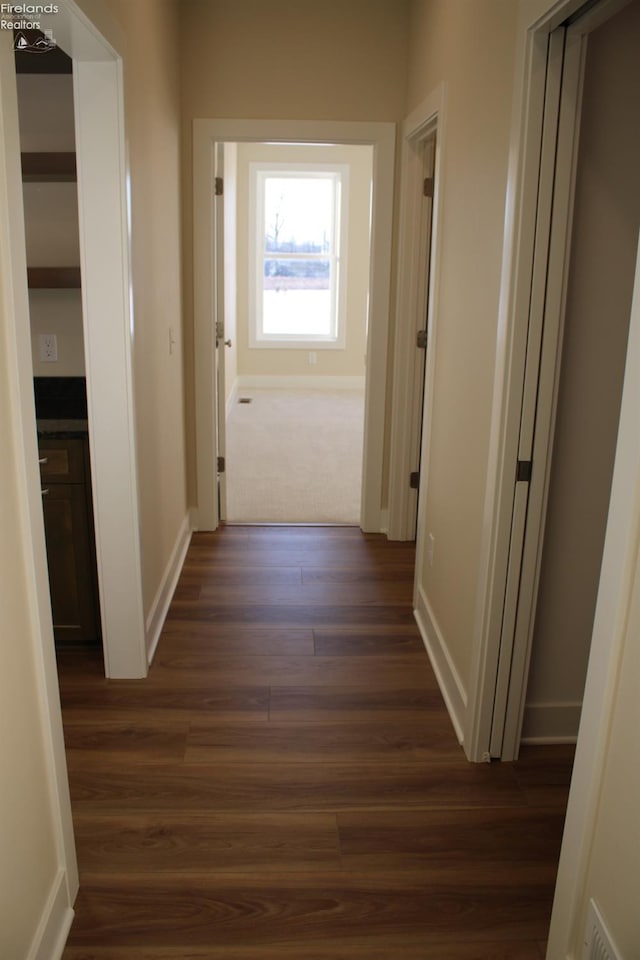 corridor with dark wood-type flooring