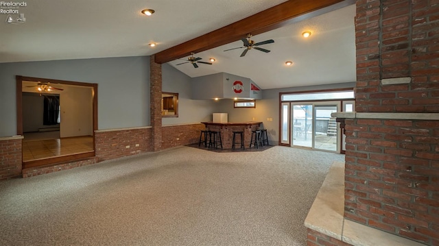 unfurnished living room with bar, vaulted ceiling with beams, carpet, brick wall, and a baseboard radiator