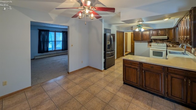 kitchen with sink, white electric range, baseboard heating, fridge with ice dispenser, and tasteful backsplash