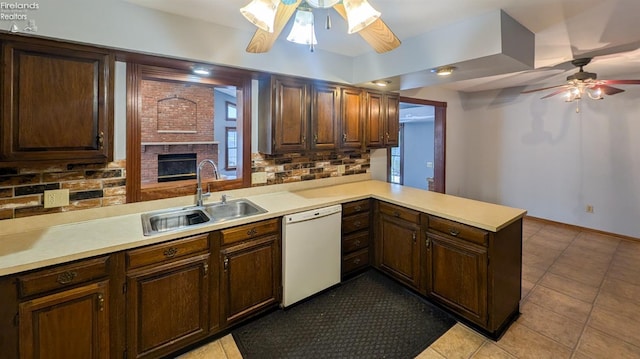 kitchen featuring sink, tasteful backsplash, kitchen peninsula, dishwasher, and ceiling fan