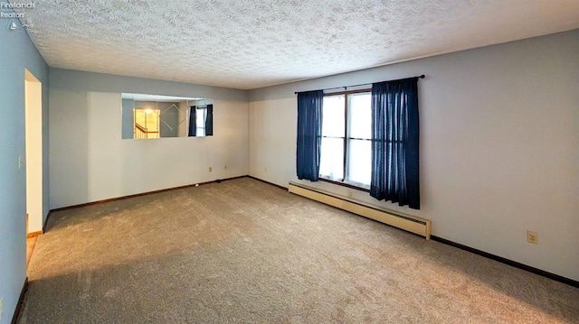 spare room featuring light colored carpet, a textured ceiling, and baseboard heating