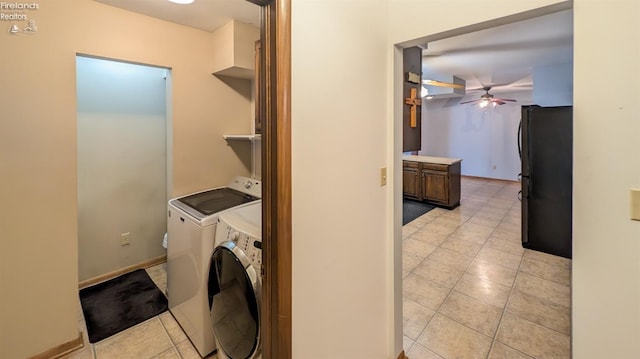 laundry area featuring separate washer and dryer, light tile patterned floors, and ceiling fan