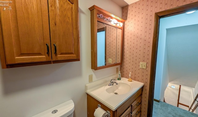 bathroom featuring vanity and toilet