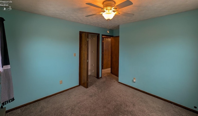 unfurnished bedroom with ceiling fan, light colored carpet, and a textured ceiling