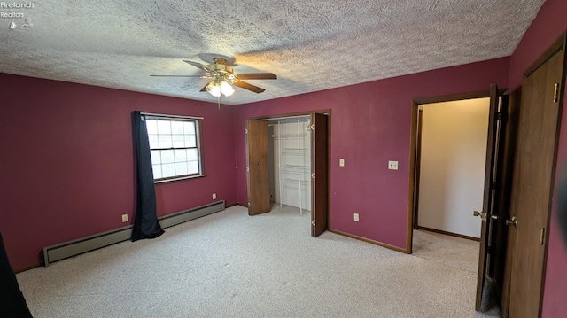 unfurnished bedroom featuring light carpet, a textured ceiling, a baseboard radiator, a closet, and ceiling fan