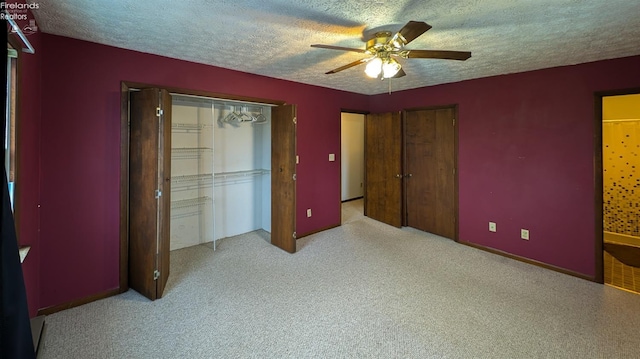 unfurnished bedroom with ceiling fan, light colored carpet, and a textured ceiling