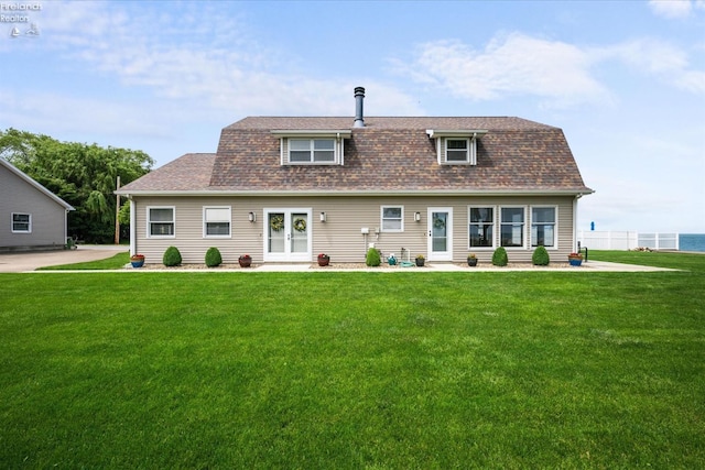 back of house with a lawn and french doors