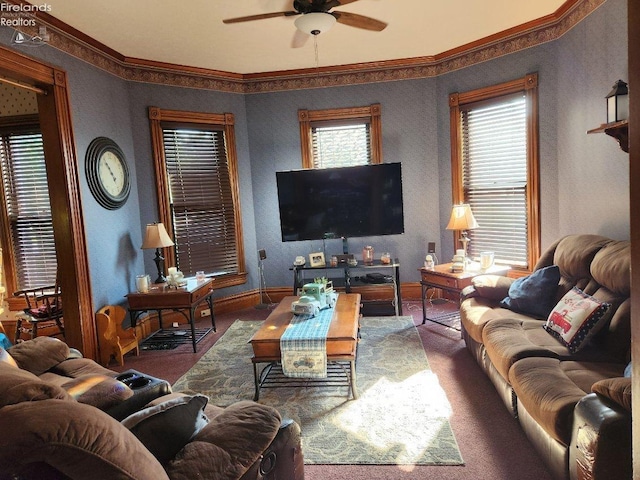 carpeted living room with crown molding and ceiling fan