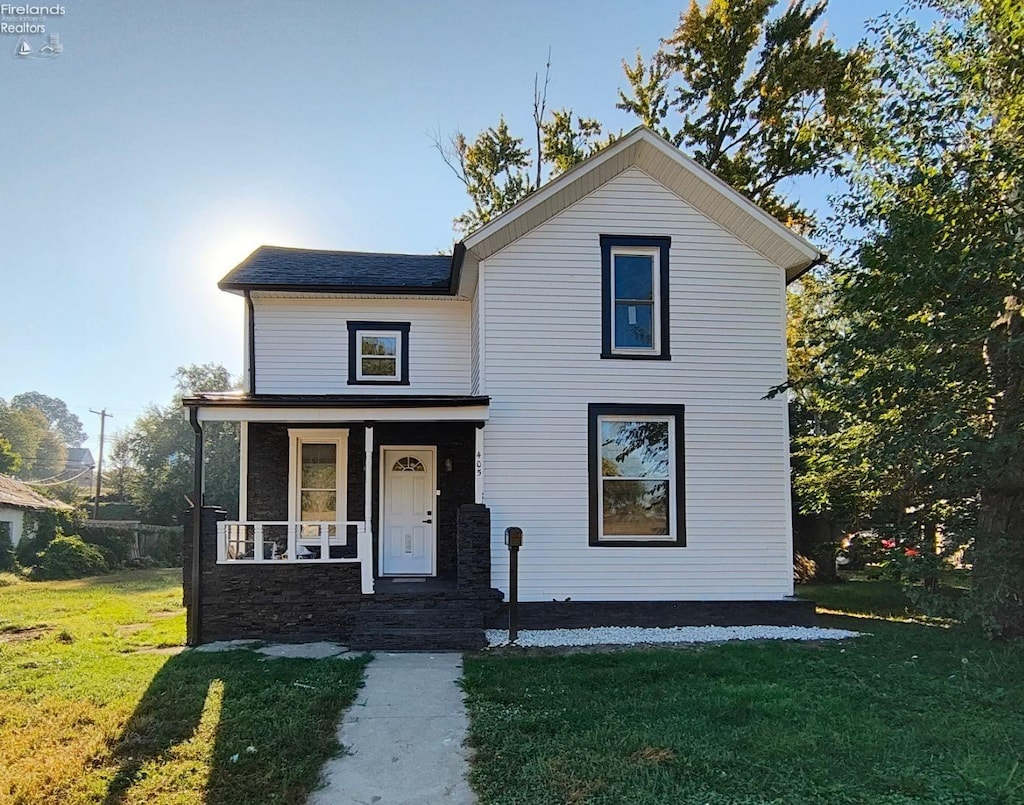 front of property featuring a front lawn and a porch