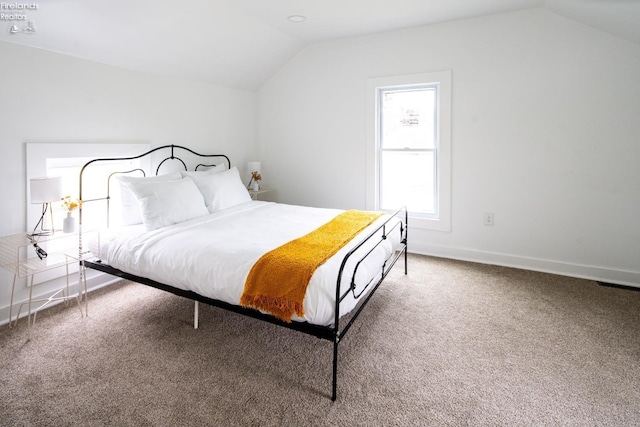 bedroom with lofted ceiling and carpet floors