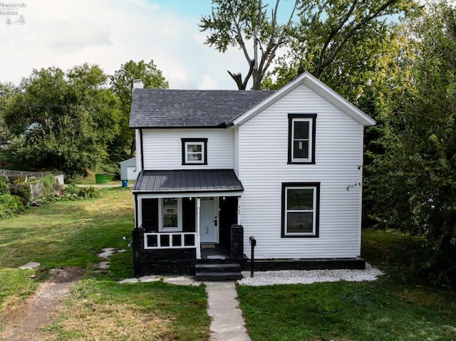 view of front of property with a front lawn and covered porch