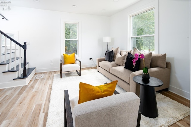 living room with a healthy amount of sunlight and light hardwood / wood-style floors