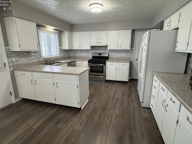 kitchen featuring white cabinetry, appliances with stainless steel finishes, dark hardwood / wood-style floors, and sink