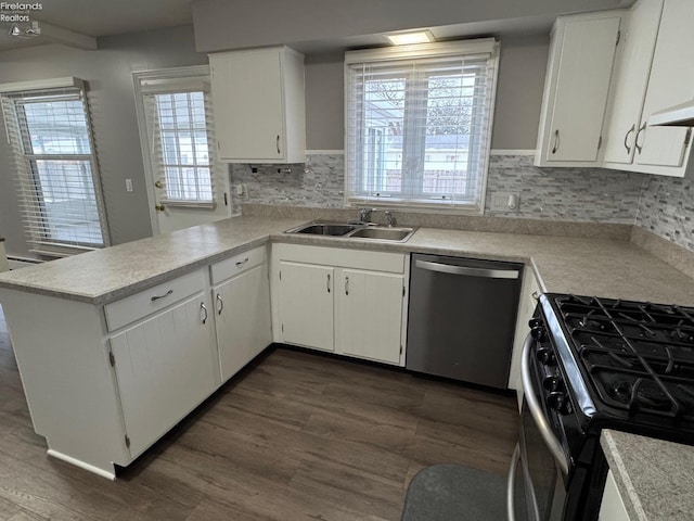 kitchen featuring sink, stainless steel dishwasher, gas stove, and white cabinets