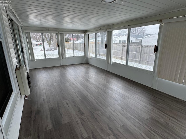 unfurnished sunroom featuring a wall mounted AC