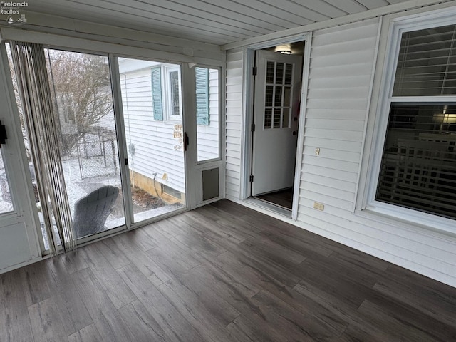 unfurnished sunroom with wooden ceiling