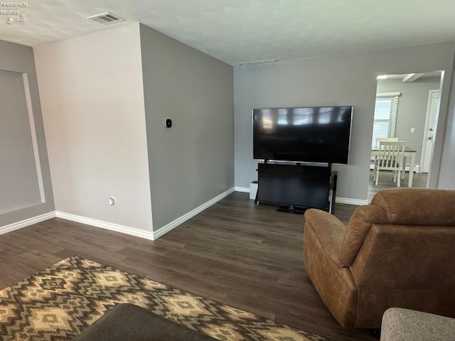 living room with dark hardwood / wood-style flooring