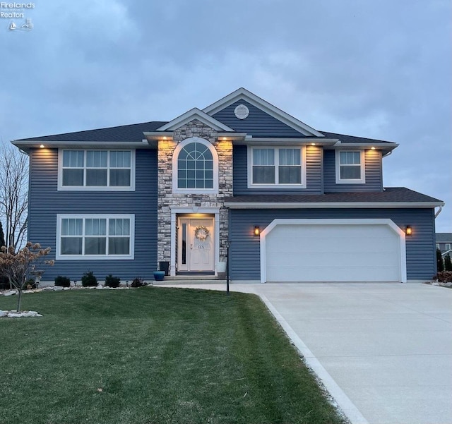 view of front of home featuring a garage and a front yard