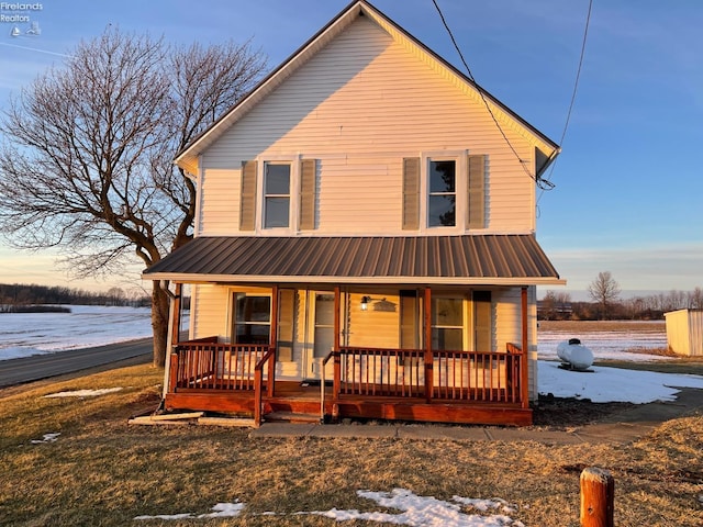 view of front of house featuring a water view and a porch