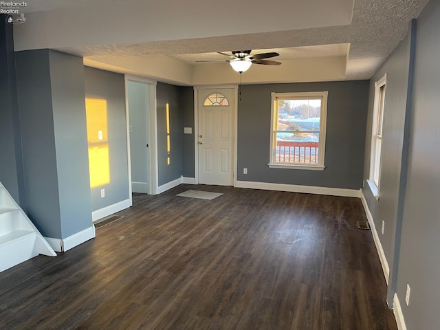 interior space featuring dark hardwood / wood-style flooring, ceiling fan, and a textured ceiling