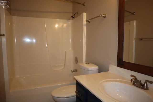 full bathroom featuring vanity, bathing tub / shower combination, and toilet