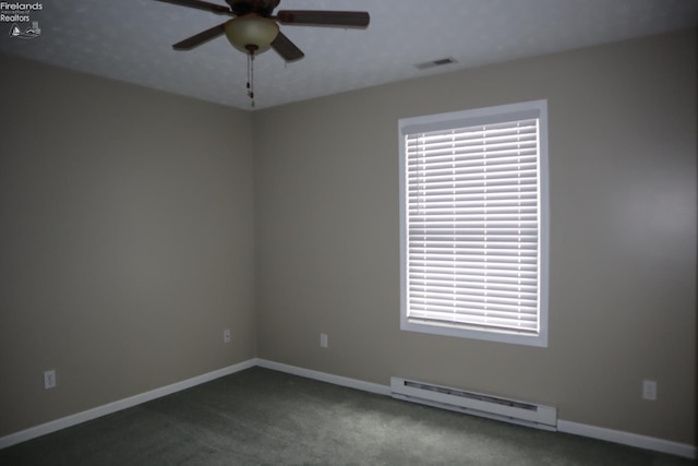 spare room with a baseboard radiator, dark carpet, ceiling fan, and a healthy amount of sunlight