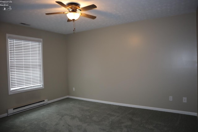 spare room with ceiling fan, dark carpet, a textured ceiling, and a baseboard heating unit