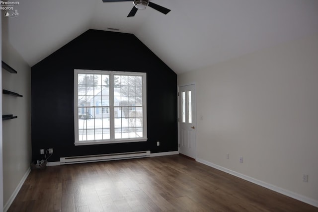 spare room with lofted ceiling, dark hardwood / wood-style floors, ceiling fan, and baseboard heating