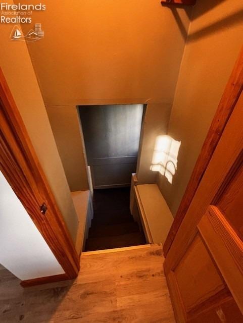 stairway with hardwood / wood-style flooring