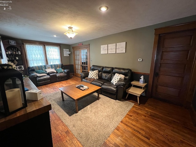 living room with hardwood / wood-style flooring and a textured ceiling