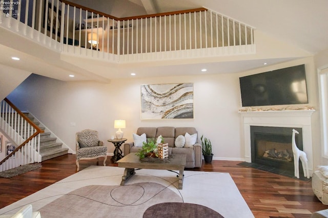 living room featuring dark hardwood / wood-style floors and a high ceiling