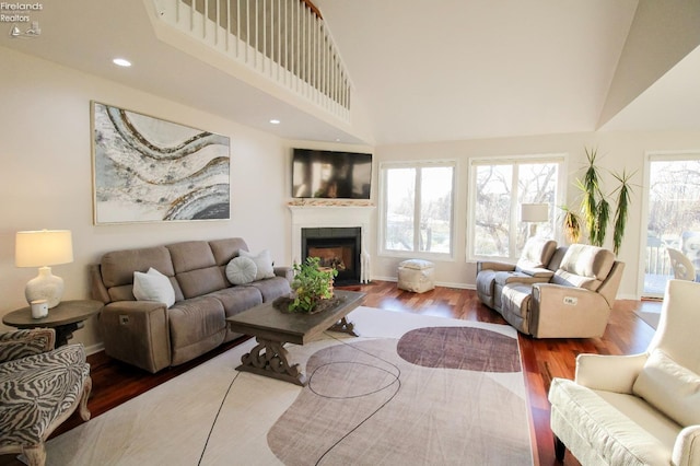 living room with a towering ceiling and hardwood / wood-style floors