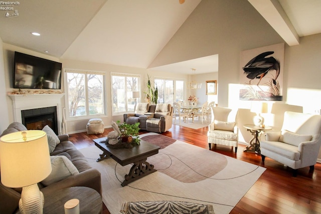 living room featuring wood-type flooring and high vaulted ceiling