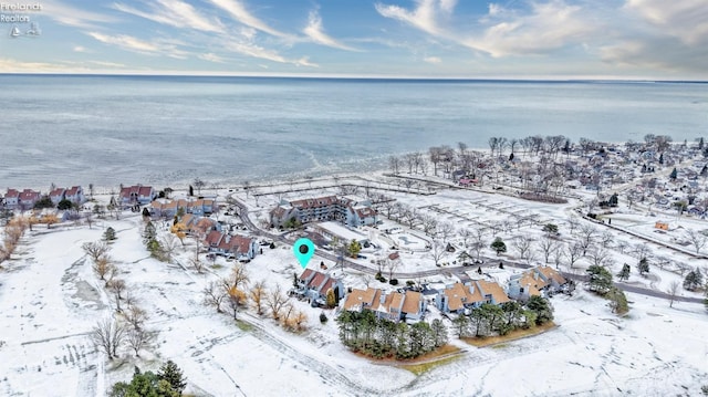 snowy aerial view with a water view