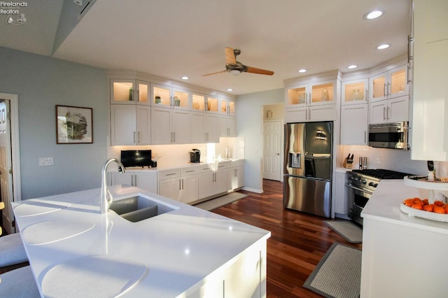 kitchen with dark hardwood / wood-style flooring, sink, white cabinets, and appliances with stainless steel finishes