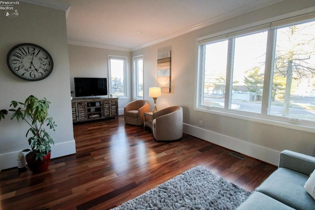 living area featuring crown molding, plenty of natural light, and dark wood-type flooring