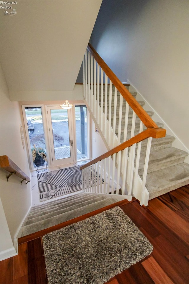 stairs featuring hardwood / wood-style flooring