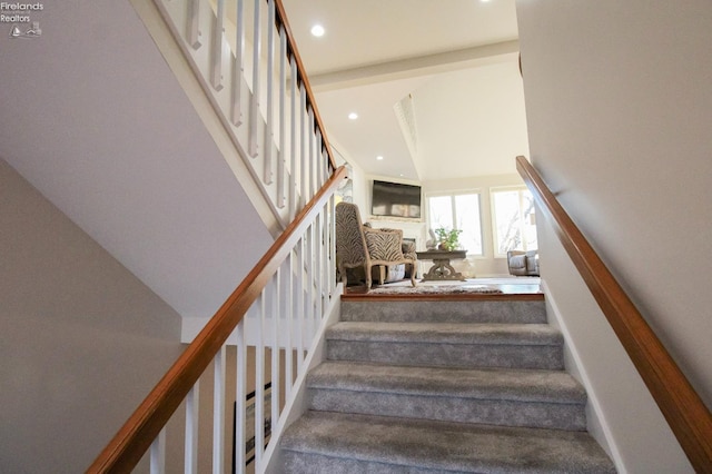 stairs featuring a high ceiling